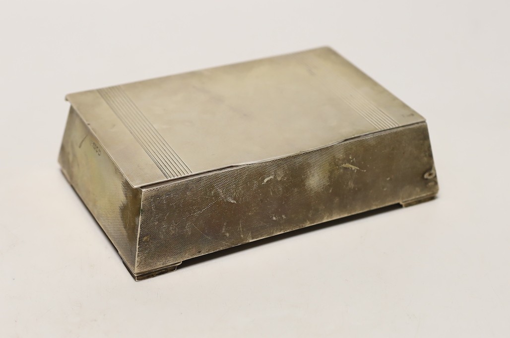A George VI engine turned silver mounted cigarette box, of tapering rectangular form, the lid interior with engraved inscription relating to the Royal Hong Kong Golf Club, London, 1947, 17.7cm.